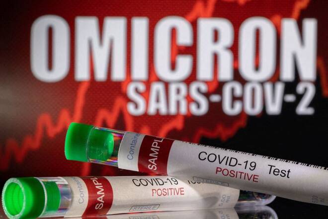 Illustration shows test tubes labelled "COVID-19 Test Positive" in front of displayed words "OMICRON SARS-COV-2
