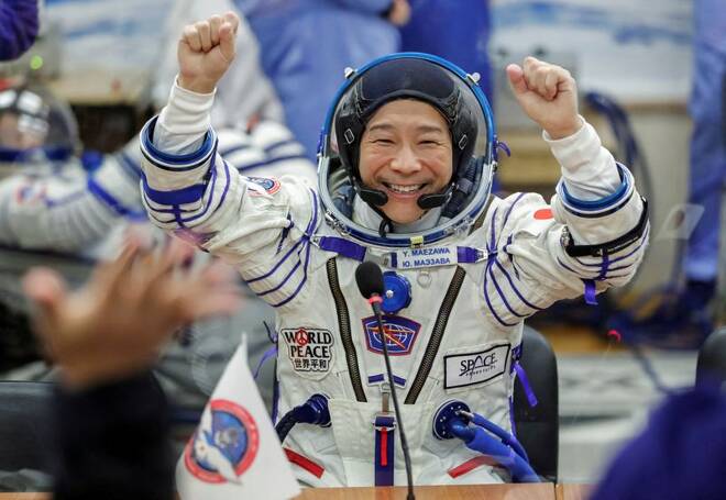 Japanese entrepreneur Yusaku Maezawa reacts as he speaks with his family after donning space suits shortly before the launch to the International Space Station (ISS) at the Baikonur Cosmodrome
