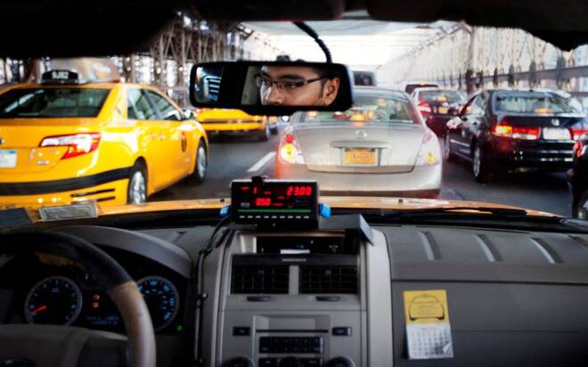 A taxi driver navigates through heavy traffic during Memorial Day over the Brooklyn Bridge in New York