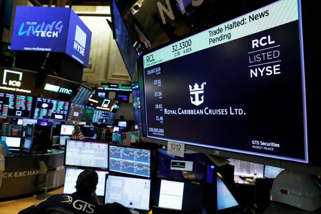 Traders wait for stocks to resume trading on Royal Caribbean Cruises Ltd. on the floor of the New York Stock Exchange in New York