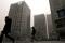 People walk past an office and commercial complex in Beijing's Central Business District (CBD)