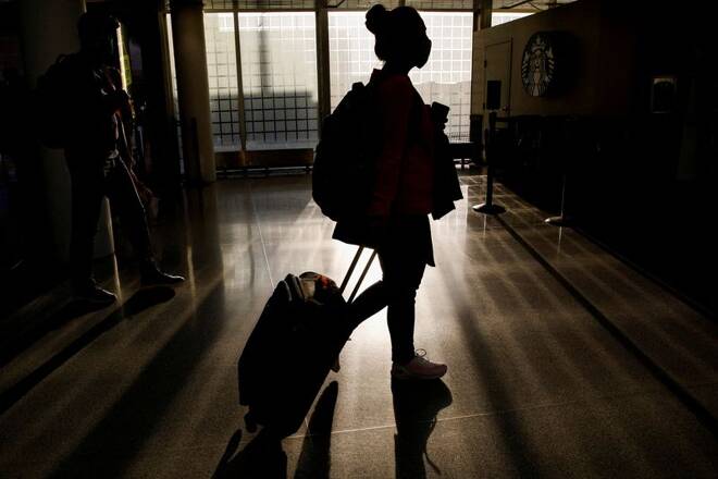 A traveler walks through O'Hare International Airport ahead of the Thanksgiving holiday in Chicago, Illinois