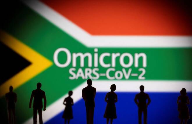 Small toy figures are seen in front of a displayed South Africa flag and words "Omicron SARS-CoV-2" in this illustration taken