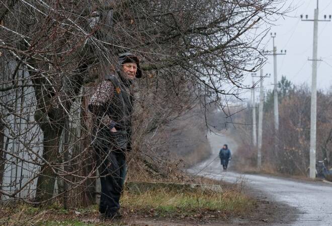 Local resident Kudla stands at a street near his house near the front line in the village of Zaitseve