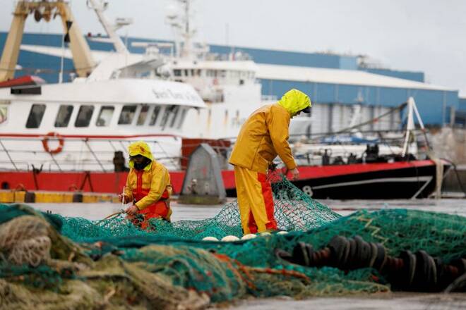 French fishermen repair their nets at Boulogne-sur-Mer, northern France