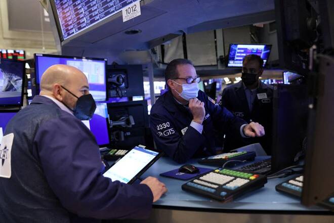 Traders wearing face masks work on the trading floor at the New York Stock Exchange (NYSE) in New York City