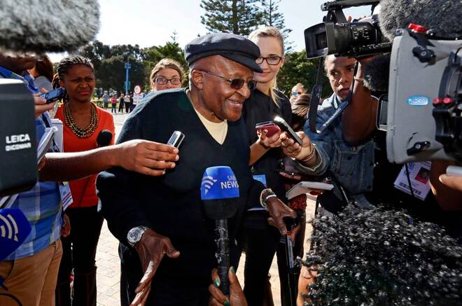 Archbishop Desmond Tutu speaks to the media as he arrives to cast his vote during the South African election in Cape Town