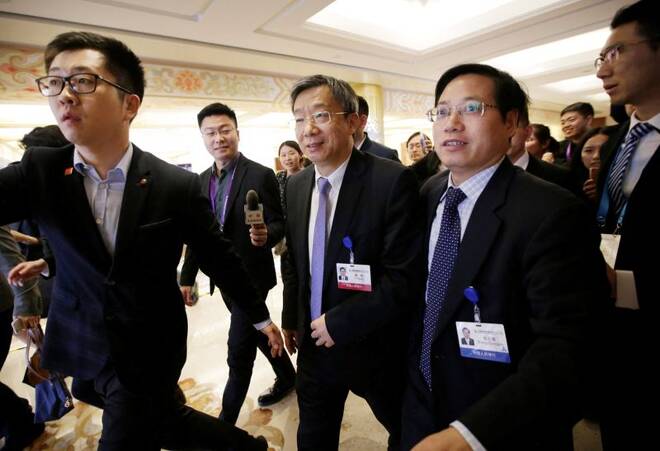 China's new Central Bank Governor Yi Gang leaves after a speech in Beijing
