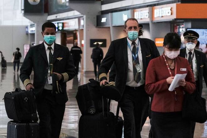 Pilots wear protective face masks at the airport, following the outbreak of the new coronavirus, in Hong Kong