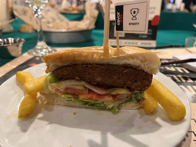 A plant-based hamburger, cooked by a robot developed by Israeli food-tech company SavorEat is served at a restaurant