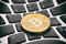 Golden bitcoin coin on keyboard