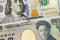 closeup of american dollar and yen- concept of currency exchange
