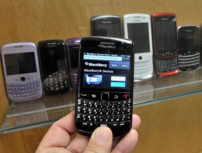 A BlackBerry device is shown in front of products displayed in a glass cabinet at the Research in Motion offices in Waterloo