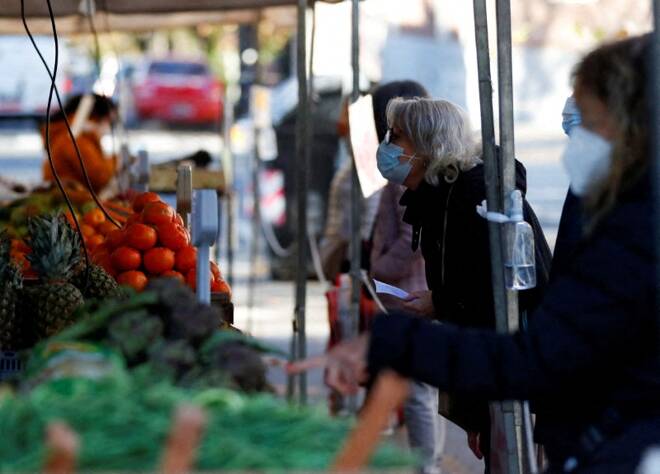A customer asks for prices at a greengrocery store in a street market, in Buenos Aires