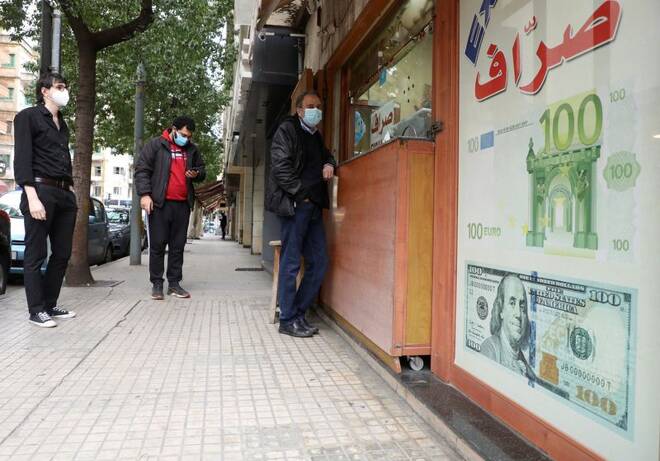 People wait outside a currency exchange shop to exchange money in Beirut