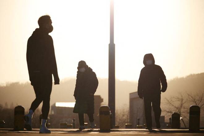 People wearing masks to prevent contracting the coronavirus disease (COVID-19) take a walk on a cold winter day at a Han river park in Seoul