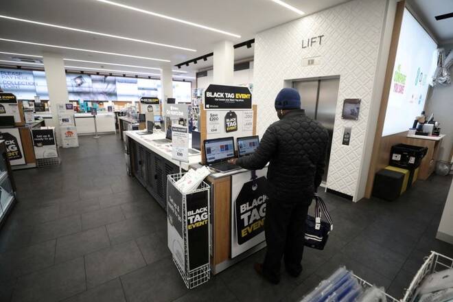 A customer stands in Currys PC World store on Oxford Street on 'Black Friday' in London