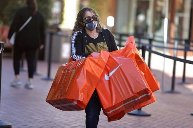 A woman carries Nike shopping bags at the Citadel Outlet mall, as the global outbreak of the coronavirus disease (COVID-19) continues, in Commerce