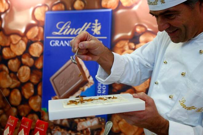 A Maitre Chocolatier of Swiss chocolatier Lindt & Spruengli prepares a chocolate after the annual news conference in Kilchberg