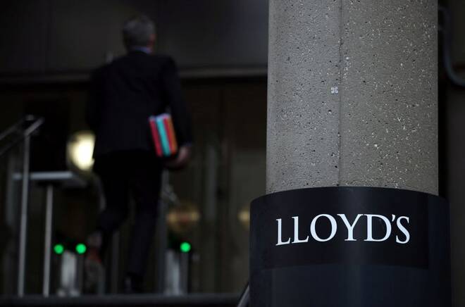 Man enters the Lloyd's of London building in the City of London financial district