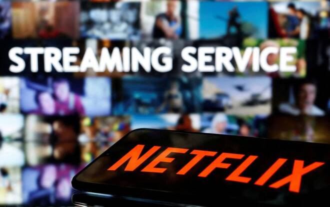 A smartphone with the Netflix logo lies in front of the displayed words "Streaming service" in this illustration