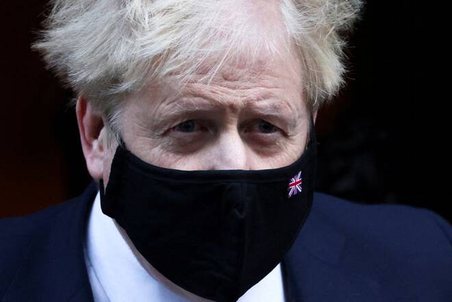 British Prime Minister Johnson walks outside Downing Street in London