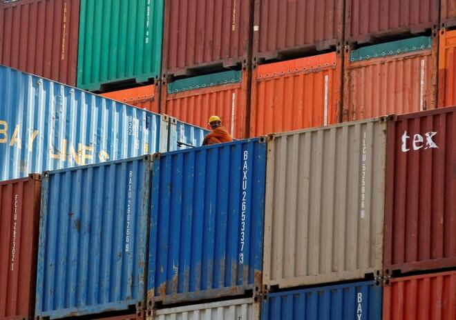 FILE PHOTO - A worker sits on a ship carrying containers at Mundra Port in the western Indian state of Gujarat