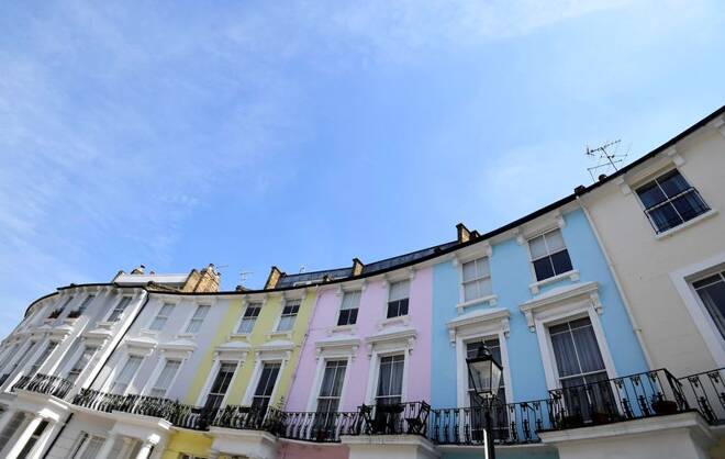 Houses are seen painted in various colours in a residential street in London