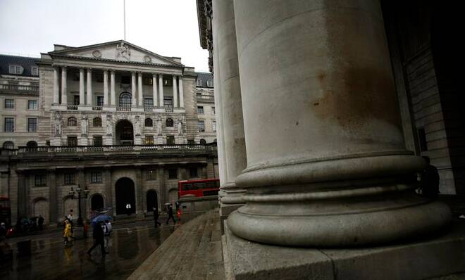 Members of the public walk past the Bank of England in central London