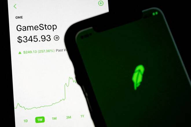 Trading information for GameStop is displayed on the Robinhood App as another screen displays the Robinhood logo