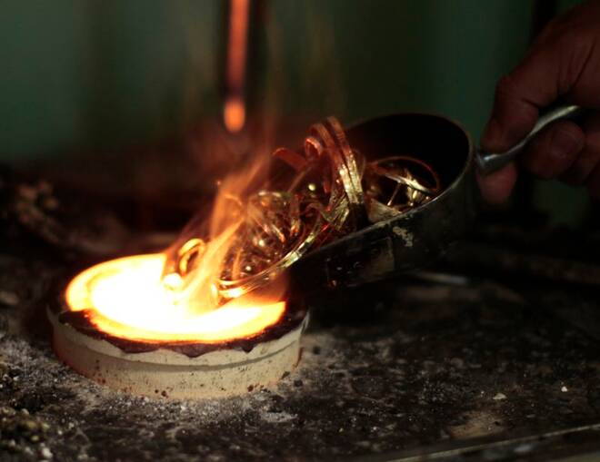 FILE PHOTO - A man melts down gold jewelry in Los Angeles