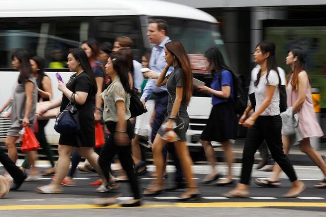 Office workers cross a street in Singapore's central business district