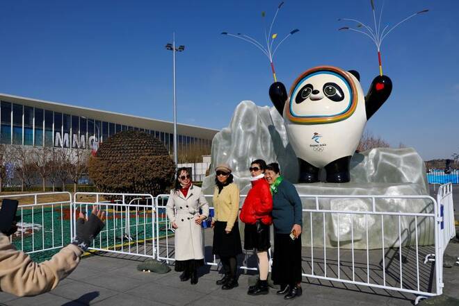 People pose for pictures near an installation of the Beijing 2022 Olympics mascot Bing Dwen Dwen, ahead of the closing ceremony of the Beijing 2022 Winter Olympic Games, in Beijing