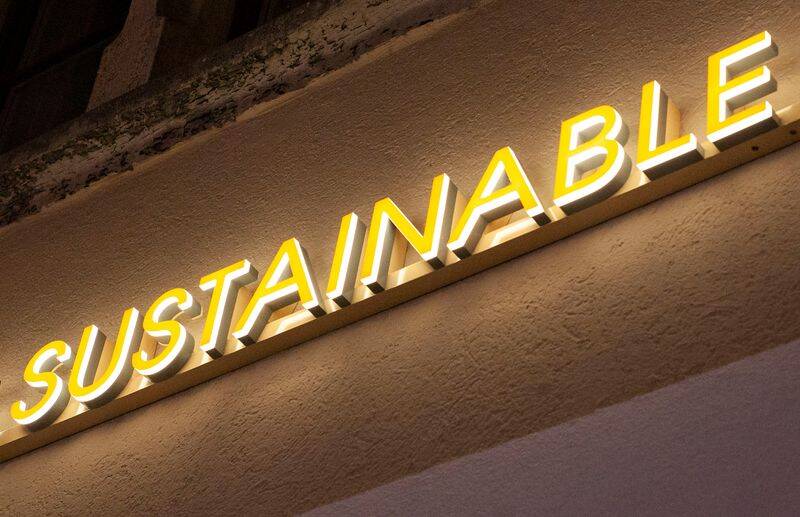 The illuminated word "sustainable" is seen outside a shop in Zurich