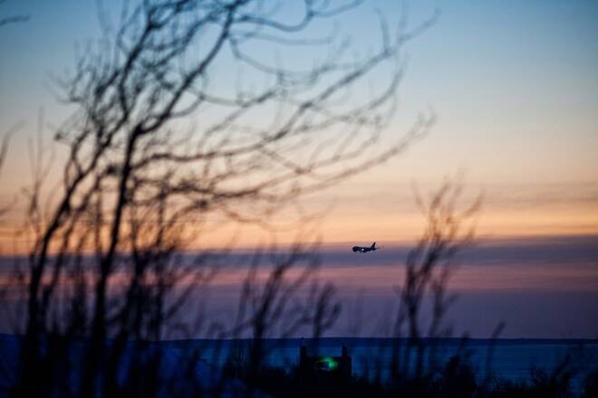 A passenger plane approaches Ted Stevens Anchorage International Airport on a cold and clear day in Achorage Alaska