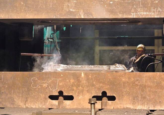 An employee works with a titanium ingot at the VSMPO-Avisma factory in Verkhnyaya-Salda