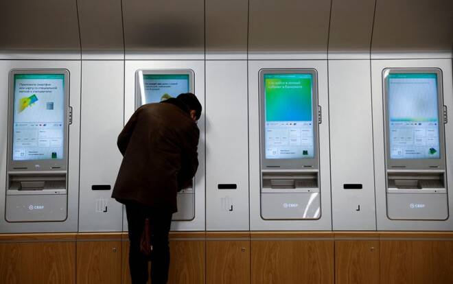 A man uses an ATM machine in an office of the Russian largest lender Sberbank in Moscow
