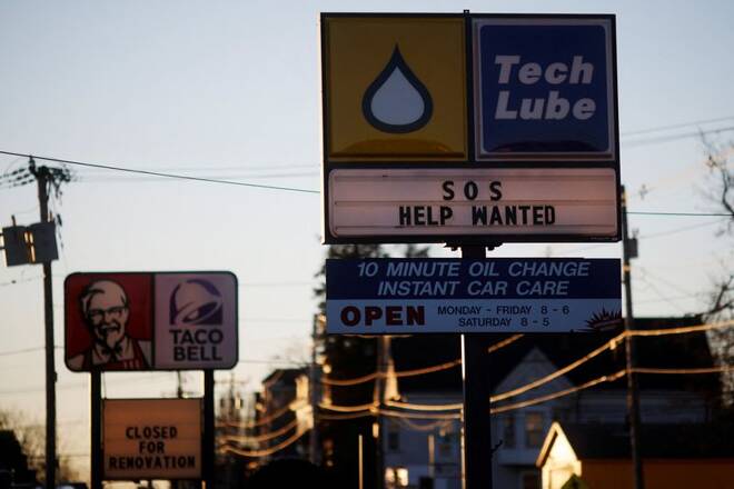 The sign at automobile oil-change shop reads "SOS Help Wanted", in Brockton