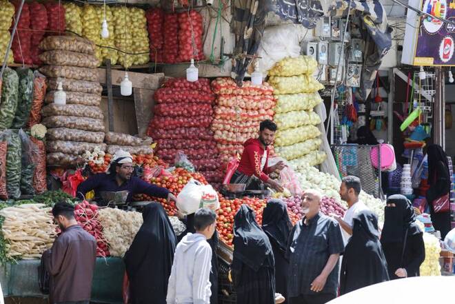 People shop for vegetables hours before a two-month nationwide truce takes effect, in Sanaa