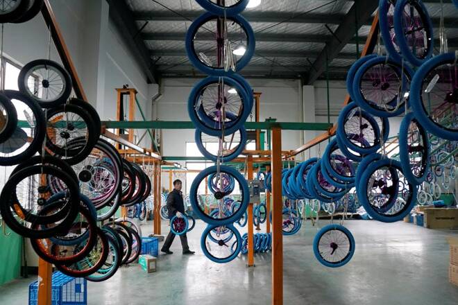 An employee works on the production line of Kent bicycles at Shanghai General Sports Co., Ltd, in Kunshan
