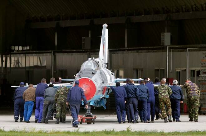 A MIG-21 Lancer belonging to Romania's Air Force is pushed back into a hangar during bilateral one-week training exercises in Transylvania