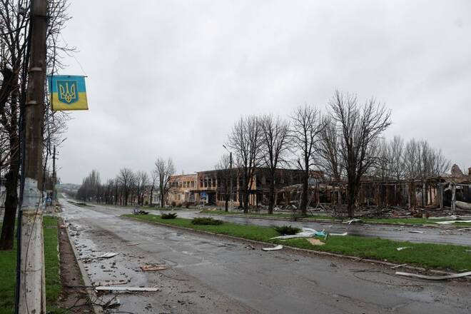 A view shows an empty street with buildings damaged by shelling in the town of Marinka