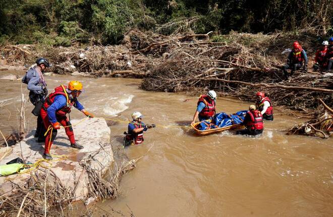 A search and rescue team prepares to airlift a body from the Mzinyathi River after heavy rains caused flooding near Durban