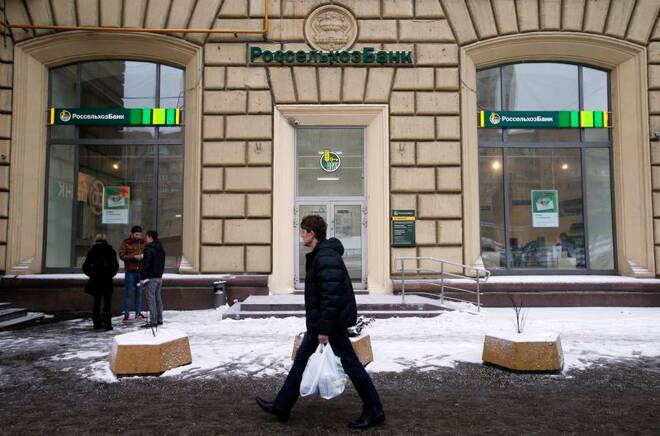 A man walks past a branch of Rosselkhozbank in Moscow