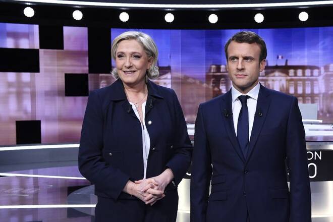 Candidates for the 2017 presidential election, Emmanuel Macron, head of the political movement En Marche !, or Onwards !, and Marine Le Pen, of the French National Front (FN) party, pose prior to the start of a debate in La Plaine-Sainte-Denis