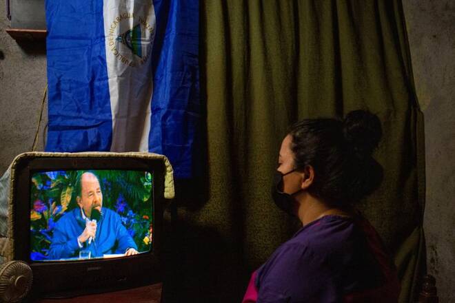 A woman watches a televised speech of Nicaraguan President Daniel Ortega, in Managua