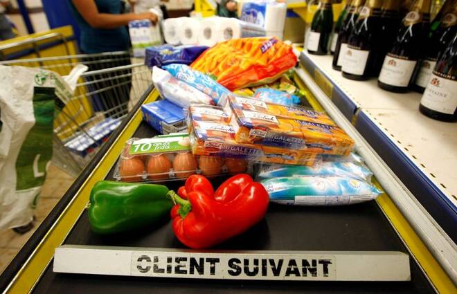 A customer pays for shopping at the cash register in a discount supermarket in Nice
