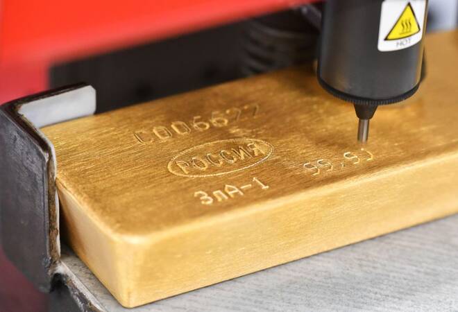 A machine engraves information on an ingot of 99.99 percent pure gold at the Krastsvetmet non-ferrous metals plant in Krasnoyarsk