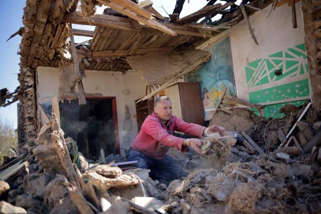 Ukrainian man removes debris from his house that was damaged by a missile attack, as Russia's invasion continues, in Zaporizhzhia