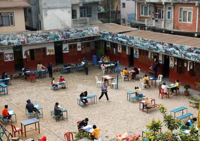 Students maintain social distance as they study inside the compound of a school amid the spread of coronavirus disease (COVID-19) outbreak in Kathmandu